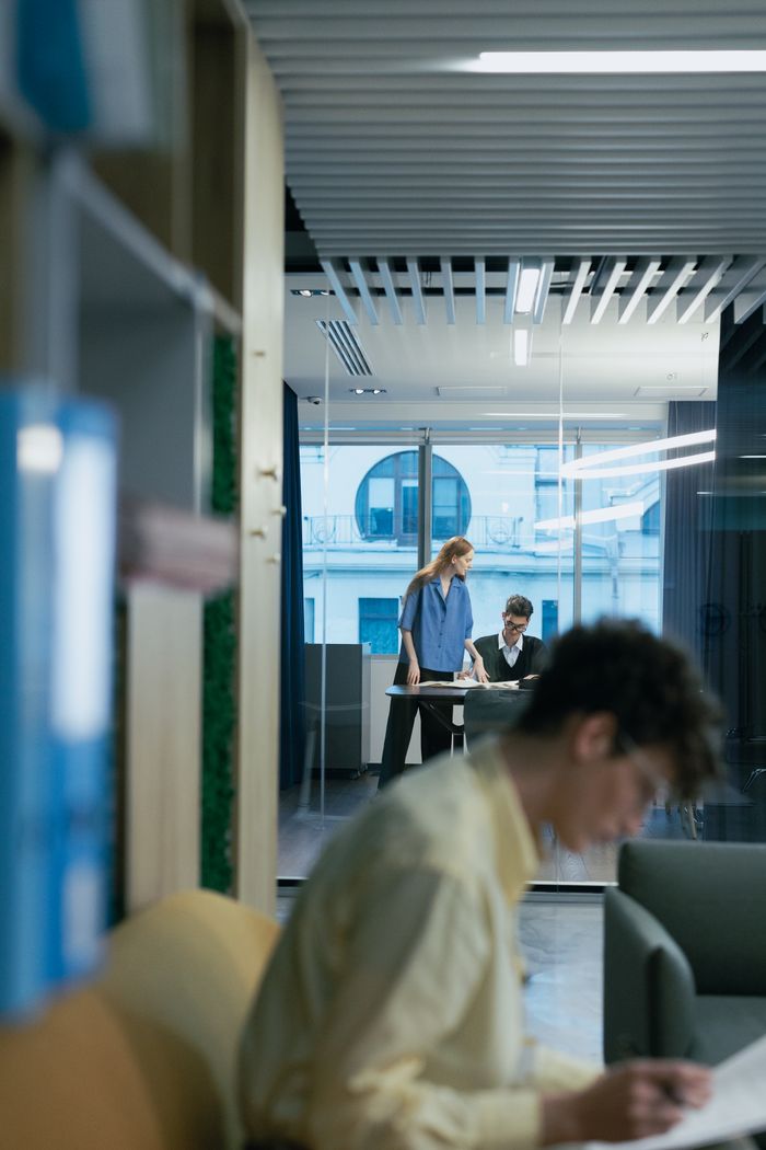 Contemporary office setting with professionals focused on work, highlighting collaboration and productivity.